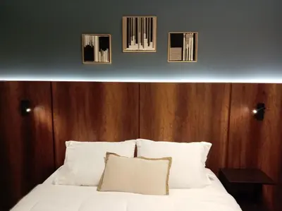 a bedroom with a bed with four pictures on the wall at Loft steps away from Larcomar for urban explorers in Lima