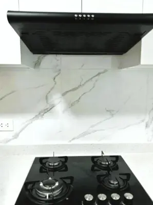 a black stove top in a kitchen with marble counters at Loft steps away from Larcomar for urban explorers in Lima