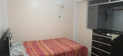 a bedroom with a bed and a flat screen tv at Departamento amoblado y comodo in San Vicente de Cañete