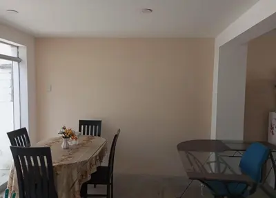 a dining room with a table and chairs at Departamento amoblado y comodo in San Vicente de Cañete