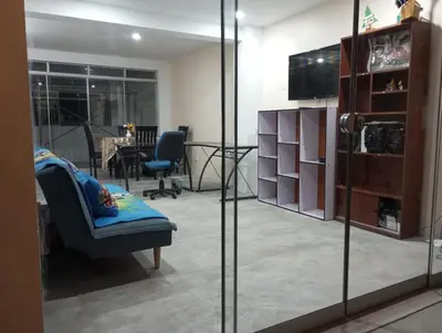 a living room with a chair and a table at Departamento amoblado y comodo in San Vicente de Cañete