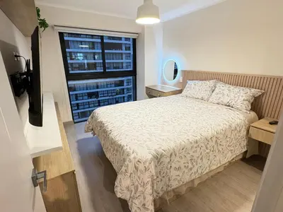 a bedroom with a bed and a large window at San Isidro Financial Flat Lima in Lima