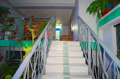 a staircase in a house with white and green tiles at Cómodo alojamiento con jardín y baño privado-Echarati