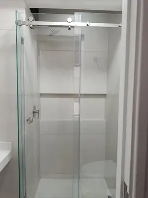 a shower with a glass door in a bathroom at HK5 Bed And Breakfast Apartment in Lima