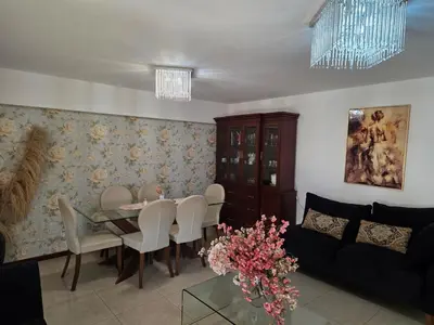 a living room with a table and a couch at Completo, Moderno y Confortable Departamento in Lima