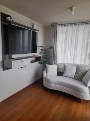 a living room with a couch and a flat screen tv at Departamento con Vista al Mar in Lima