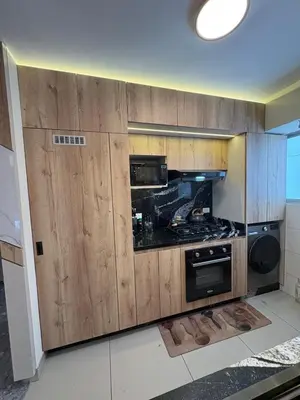 a kitchen with wooden cabinets and a stove top oven at Exclusivo new apartment in Lima in Lima