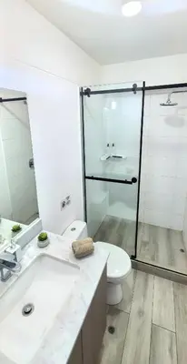 a bathroom with a sink and a toilet and a shower at Beautiful and quiet aparment, near to Larcomar, cliff, Kennedy Park in Lima