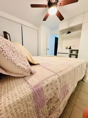 a bedroom with a bed with a ceiling fan at A unos pasos de la Arena in Puerto Viejo