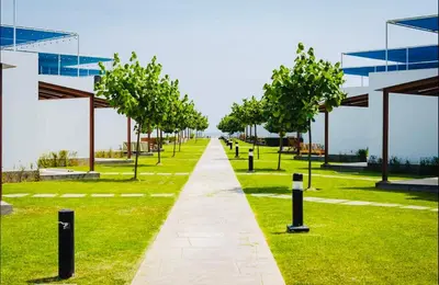 a walkway in a park with trees and a building at A unos pasos de la Arena in Puerto Viejo