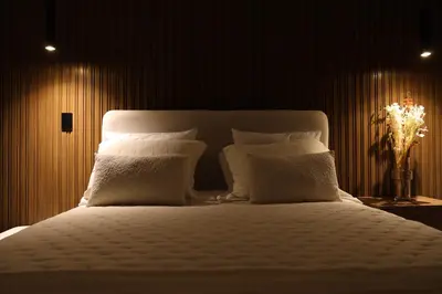 a bedroom with a white bed with white pillows at Estancia de lujo en Miraflores Entre Marriott y Pullman in Lima