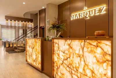 a lobby of a marupilla store with a large marble wall at El Marquez Huancayo in Huancayo