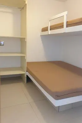 a room with a bed and shelves in it at Departamento con Jacuzzi privado y acceso directo al mar in Asia