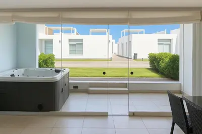 a bathroom with a tub and a large window at Departamento con Jacuzzi privado y acceso directo al mar in Asia