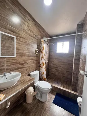 a bathroom with a sink and a toilet and a shower at Departamento en Chancay con Vista al Mar y cerca al Megapuerto