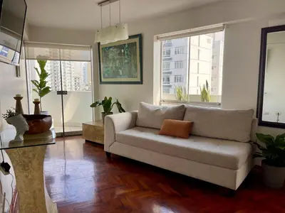 a living room with a couch and some windows at Cozy and Centric Flat with Great View and Parking in Lima