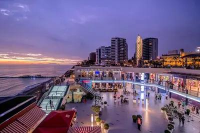 a crowd of people walking on a beach at night at Cozy and Centric Flat with Great View and Parking in Lima