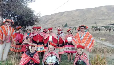 a group of people in costumes posing for a picture at hotel turismo vivencial pallay lliclla in Urubamba