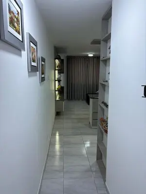 a hallway with white walls and a tile floor at Mini Departamento in Lima