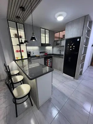 a kitchen with a counter and a black refrigerator at Mini Departamento in Lima