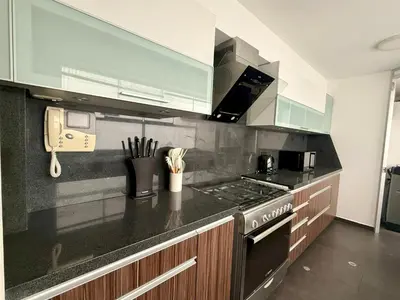 a kitchen with a stove and a counter top at Departamento Ricardo Palma in Lima