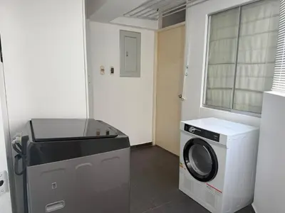 a laundry room with a washing machine and a window at Departamento Ricardo Palma in Lima