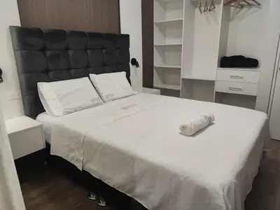 a bedroom with a large bed with a black headboard at Hospedaje Bry Ker in Pichanaki