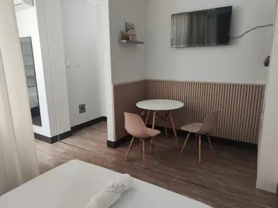 a room with a table and two chairs and a tv at Hospedaje Bry Ker in Pichanaki