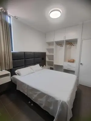 a bedroom with a large white bed in a room at Hospedaje Bry Ker in Pichanaki