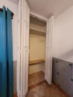 a walk in closet with a door open at Casa con Piscina privada y a pasos de la playa in Lurín