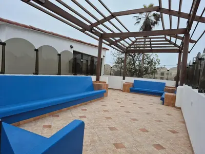 a group of blue benches on a patio at Casa con Piscina privada y a pasos de la playa in Lurín