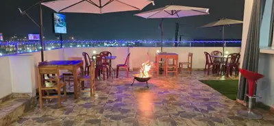 a restaurant with tables and chairs with a fire in the middle at Hotel World Peru in Lima