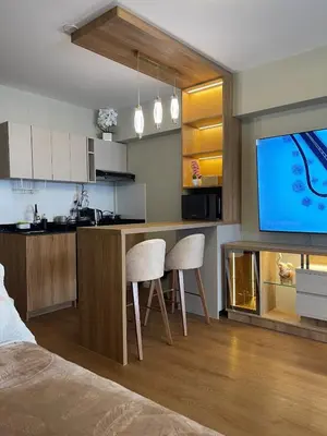 a kitchen with two chairs and a tv in a room at Mini Apartment Ares 2 in Lima