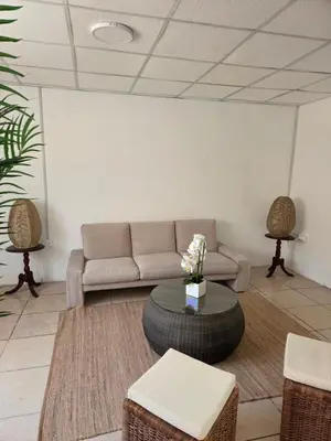 a living room with a couch and a table at tiki house in Lima