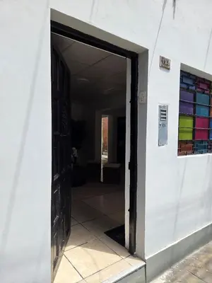 an open door to a room with colorful glass at tiki house in Lima