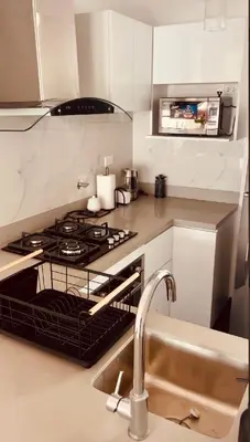 a kitchen with a stove top oven next to a sink at Luxloft in Lima