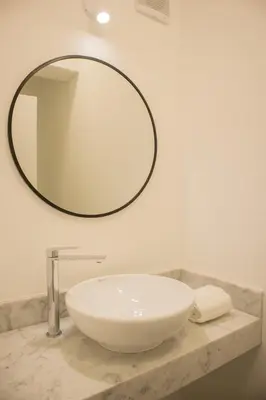 a bathroom sink with a large mirror on the wall at Seaside Apartment near Malecon Miraflores by Wynwood House in Lima