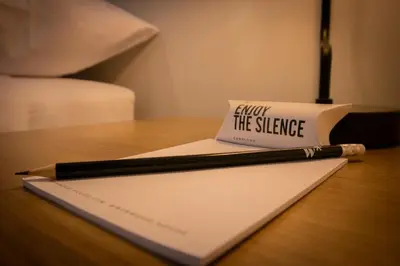 a book and a pen on a table with a napkin at Seaside Apartment near Malecon Miraflores by Wynwood House in Lima