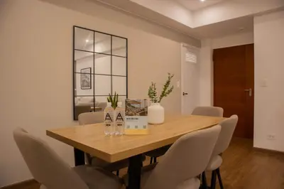 a dining room with a wooden table and chairs at Seaside Apartment near Malecon Miraflores by Wynwood House in Lima