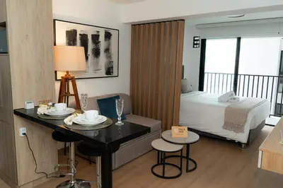 a hotel room with a bed and a table and chairs at Patria Inca Inn in Lima