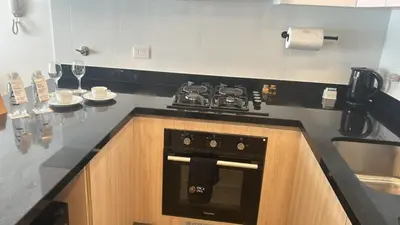 a kitchen with a stove and a counter top at Patria Inca Inn in Lima