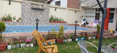 a backyard with a swimming pool and some plants at Habitación simple triple in Huayllabamba