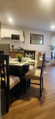 a kitchen and dining room with a table and chairs at Depa UMBRA, one block from Rebagliati Hospital in Lima