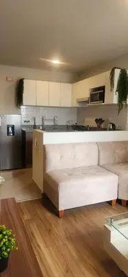 a living room with a couch and a kitchen at Depa UMBRA, one block from Rebagliati Hospital in Lima