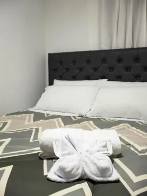 a bedroom with a bed with towels on it at Los Chullos in Cusco