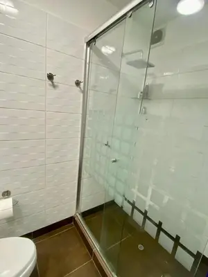 a bathroom with a glass shower and a toilet at Lovely apartment in front of malecon! in Lima
