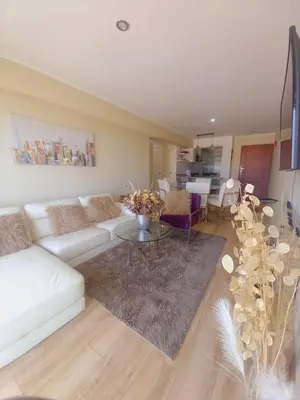 a living room with a white couch and a table at Lovely apartment in front of malecon! in Lima