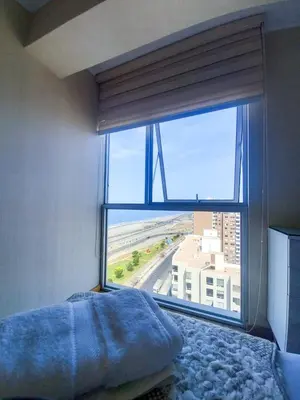 a bedroom with a large window with a view of a building at Lovely apartment in front of malecon! in Lima
