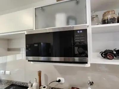 a microwave oven above a kitchen counter top at GOLD DÚPLEX único c PISCINA PRIVADA MIRAFLORES P República 5655 in Lima