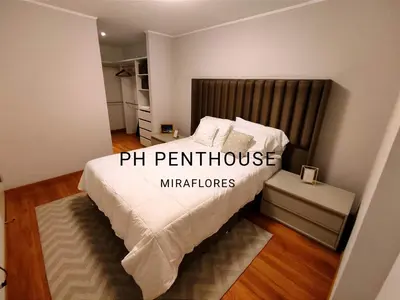 a bedroom with a bed with white sheets and pillows at GOLD DÚPLEX único c PISCINA PRIVADA MIRAFLORES P República 5655 in Lima